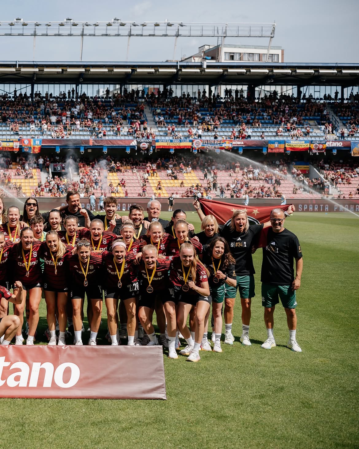 The Sparta Praha squad celebrating with medals in front of the stand