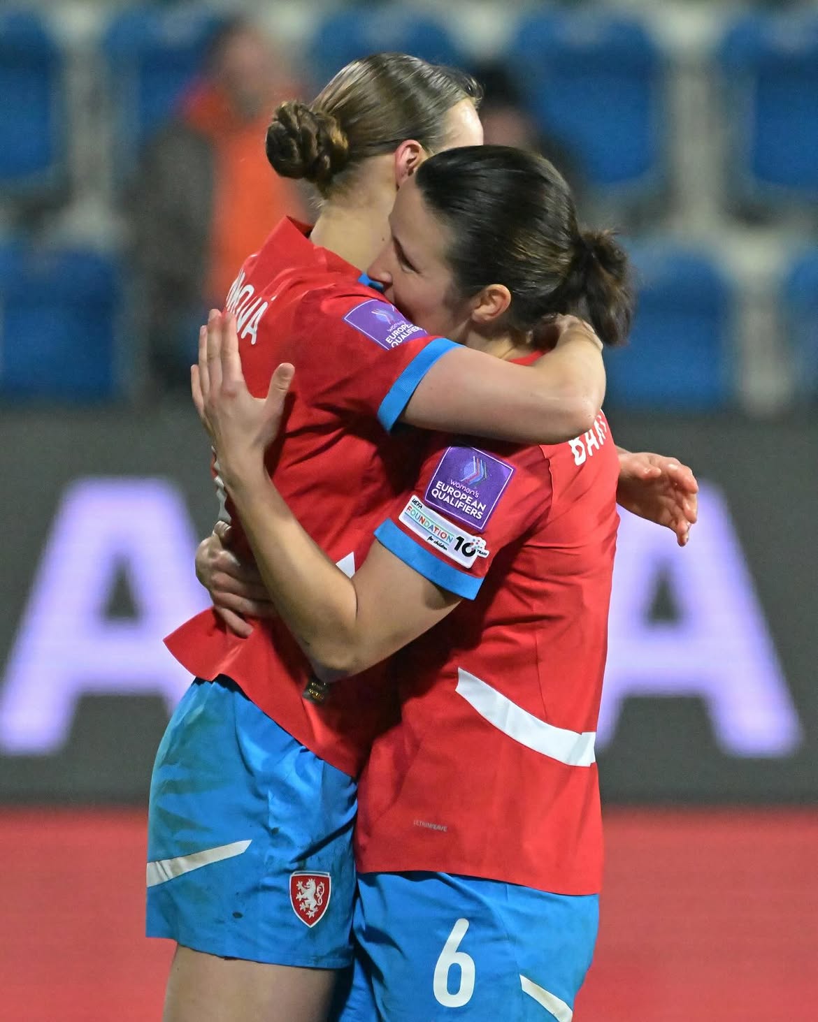 Two Czech national team players celebrating in the red home shirt