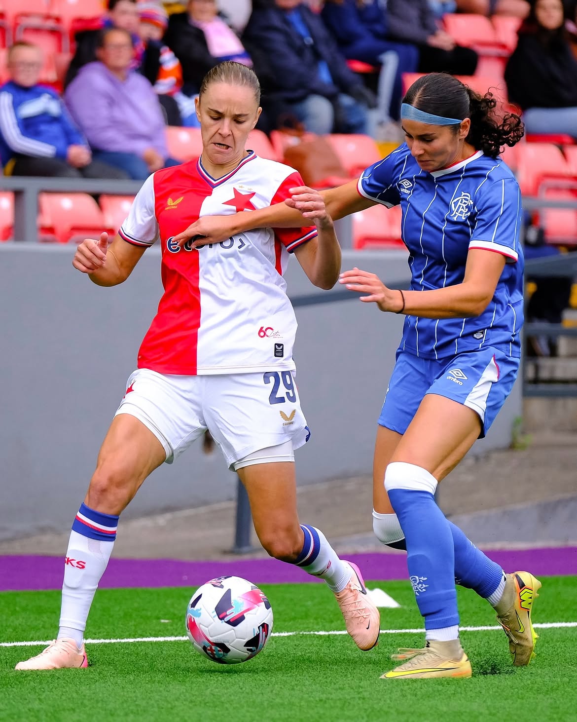A Slavia Praha player shielding the ball from a Rangers opponent on a European away day